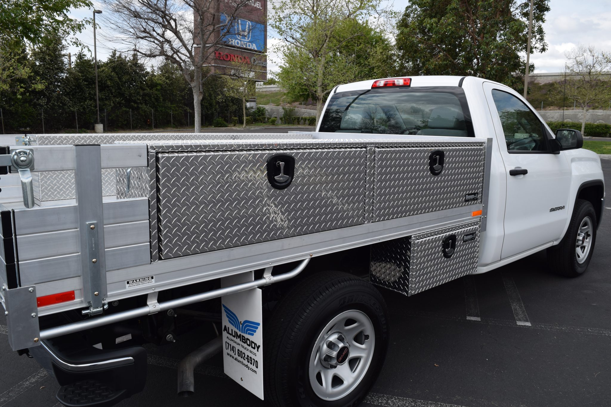 GMC Sierra 1500 with a 6’6” X 9’ AlumBody aluminum flat bed, 2 topsider tool boxes 16” X 13” X 88”, 2 underbody tool boxes 14” X 12” X 30”, and 16” fold down gates