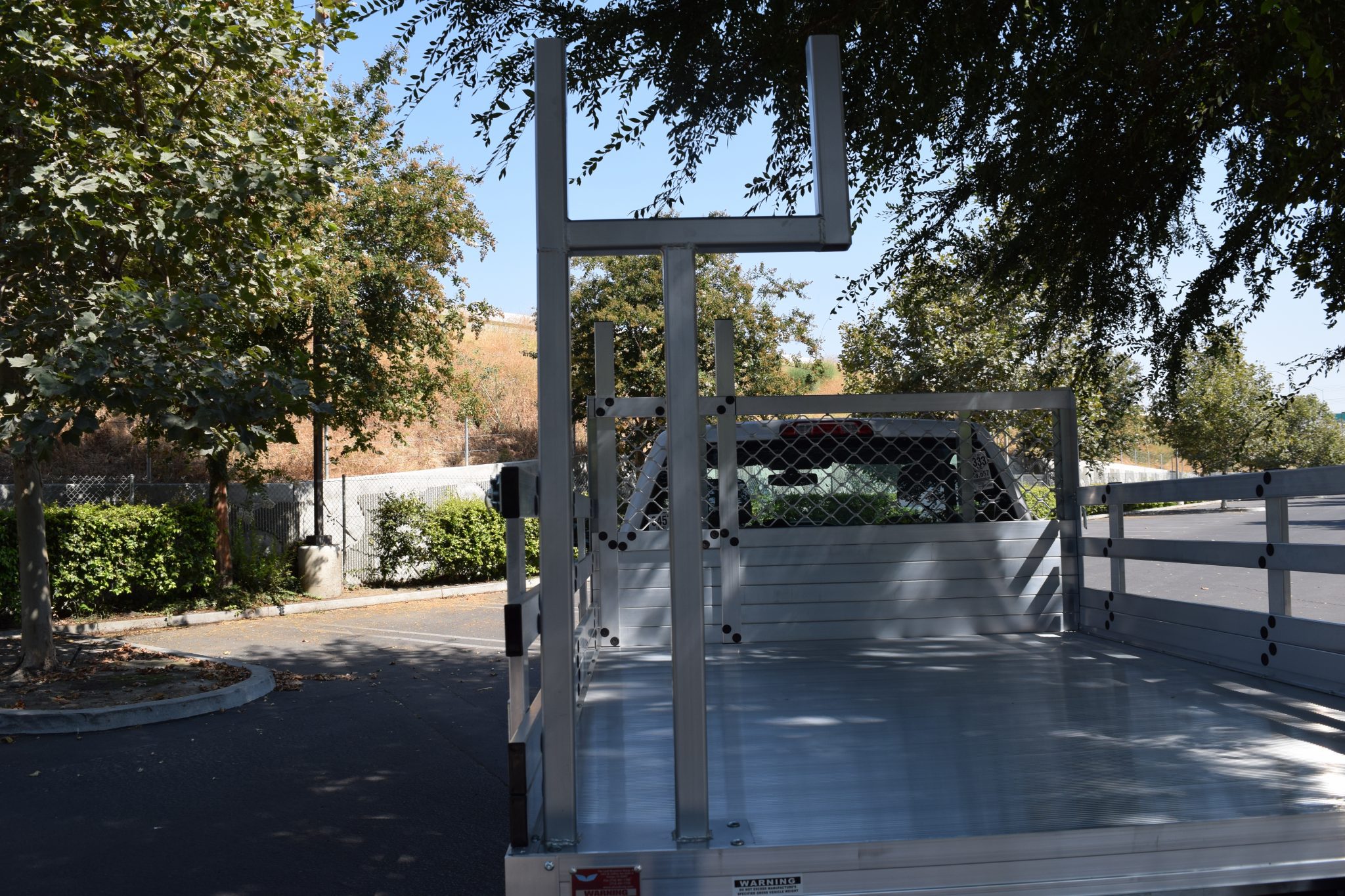 2016 GMC 1500 with AlumBody aluminum flat bed and a custom pipe rack