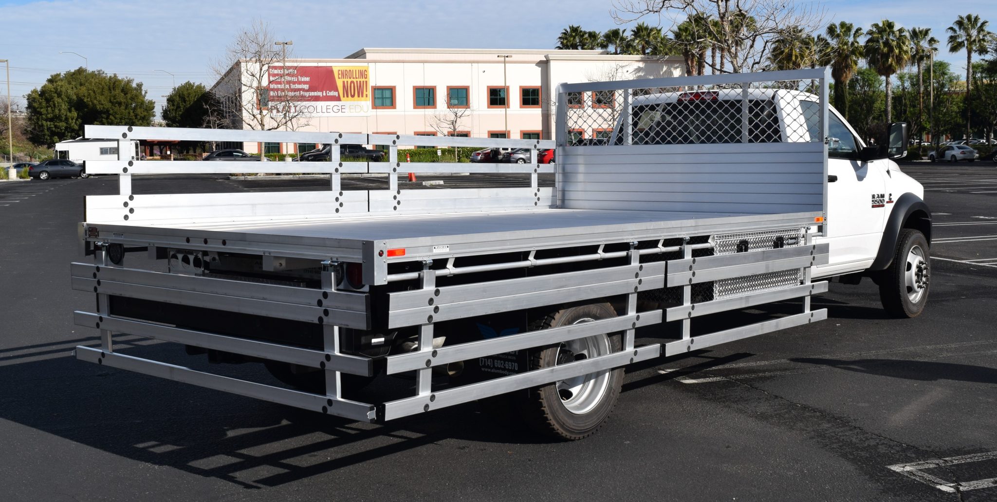 2018 Ram 5500 DRW with an 8' x 15' AlumBody aluminum flat bed with 22" fold down gates, 2 underbody tool boxes 18" X 24" X 48" and dock bumper with hitch
