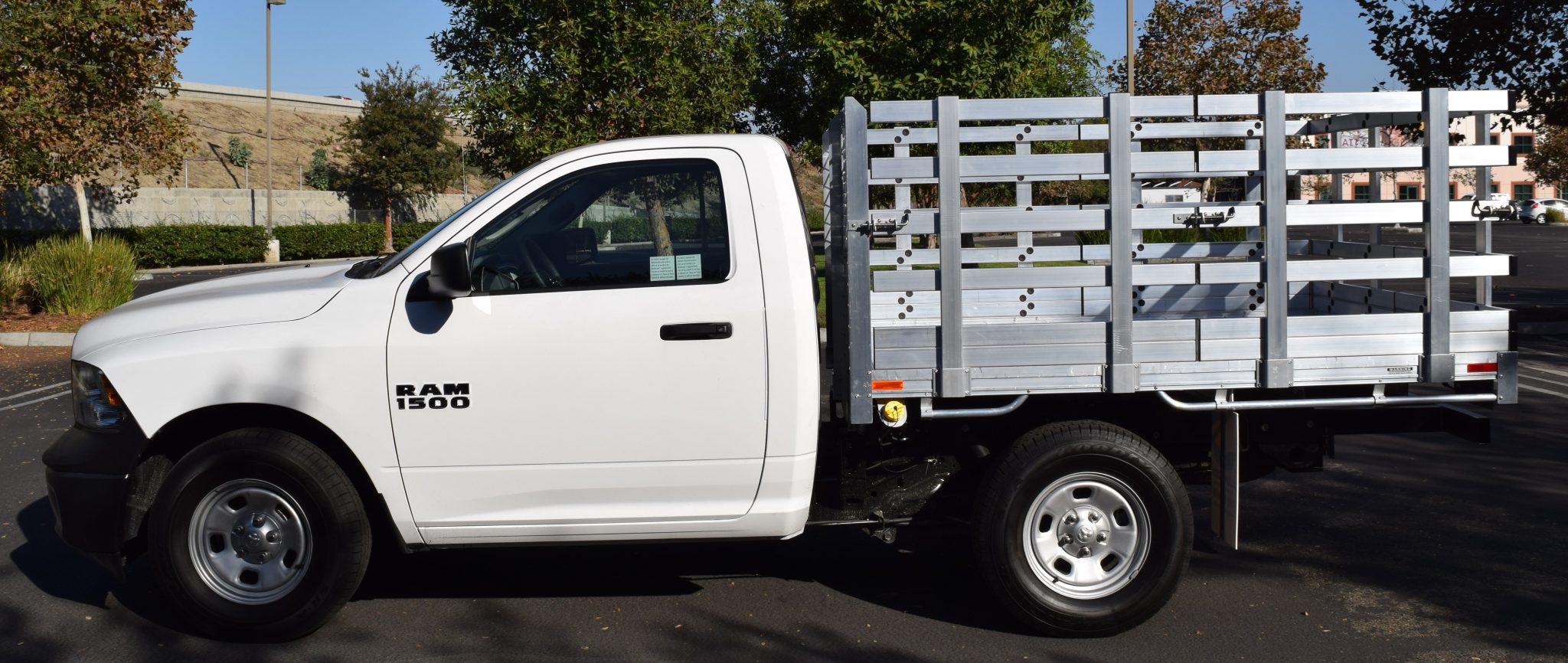 2016 Ram 1500 with a 6'6" X 7'6" AlumBody aluminum stake bed with 38" lift out stakes and dock bumper
