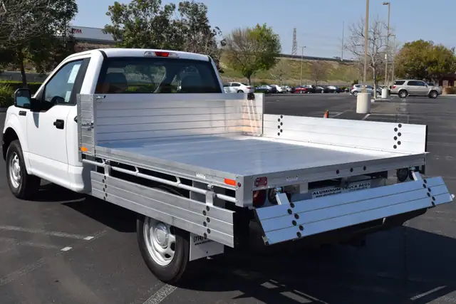 2019 Ford F150 with an 81" × 8' Alumbody aluminum pool truck bed with 9" solid fold-down gates using stainless steel hardware and the factory bumper, gates down