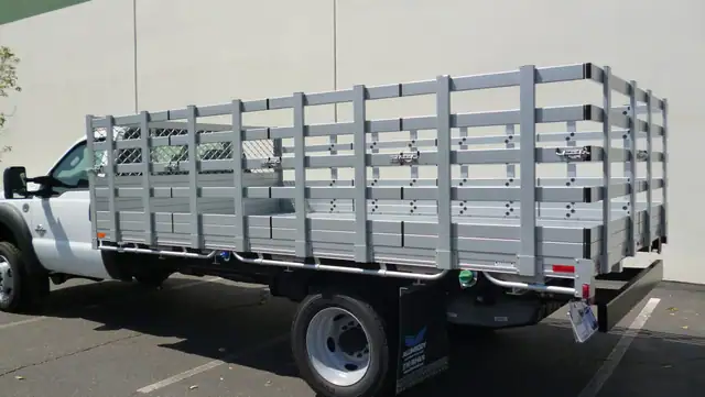 2015 Ford F550 Dual Rear Wheel with an 8' X 14' Alumbody aluminum stake bed with 38" lift out stakes and dock bumper