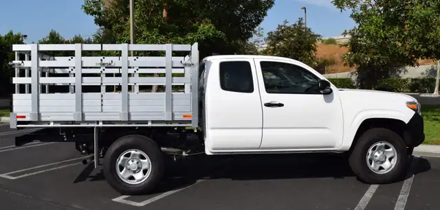 2021 Toyota Tundra, 6'6" x 7' aluminum stake bed, 38" lift-out sides with cross-bar handles, barn doors in the rear, 2-step dock bumper