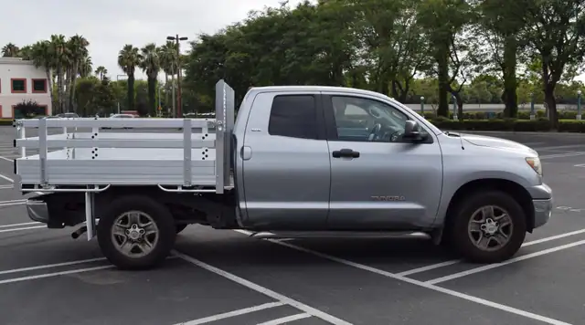2013 Toyota Tacoma with a 6'X7' Alumbody aluminum flat bed, 22" fold-down gates and dock bumper