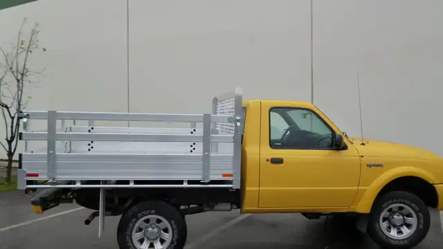 2010 Ford Ranger with a 6' X 6'6" Alumbody aluminum flat bed with 22" fold down gates using the factory bumper
