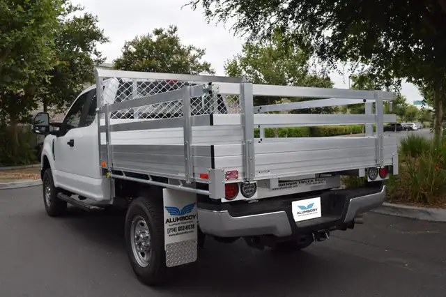 2017 Ford F250 with a 6'6" X 7'6" Alumbody aluminum flat bed with 22" fold down gates and dock bumper