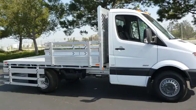2014 Mercedes-Benz Sprinter 3500 DRW with a 7' X 12' Alumbody aluminum flat bed with 22" fold down gates and dock bumper