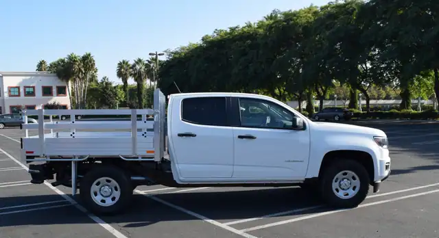 2019 Chevy Colorado 6 X 66 Aluminum Stake Bed with 22 Fold Down Gates using the Factory Bumper Side View