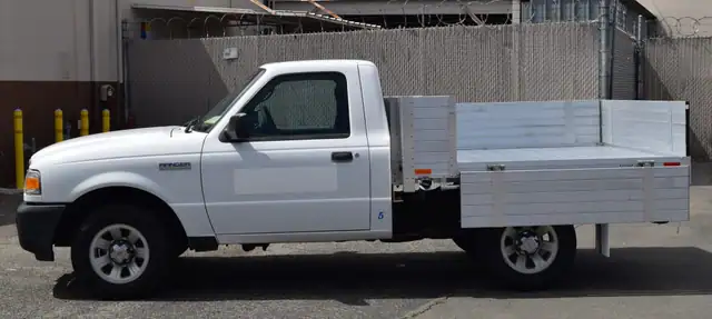 2008 Ford Ranger with a 6' X 6'6" Alumbody aluminum flat bed with 15" solid fold down gates no mesh headboard and dock bumper