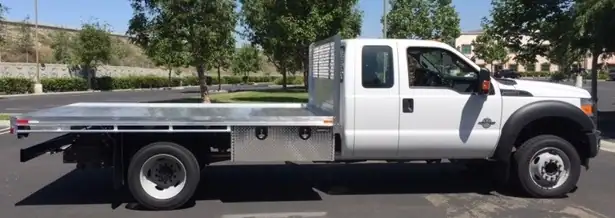 Ford F550 Dual Rear Wheel with an 8’ X 12’ Alumbody aluminum flat bed, underbody tool box 18” X 18” X 48”, and dock bumper