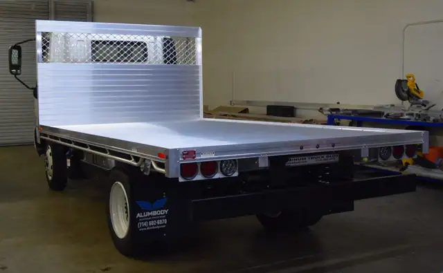 2019 Hino 195h with an 8' X 14' Alumbody aluminum flat bed with a heavy duty headboard constructed with stainless steel hardware and a dock bumper rear