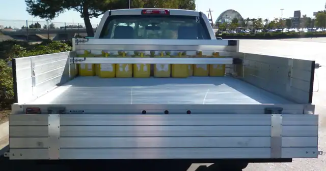 2015 Chevy 1500 with an 81" × 8' Alumbody aluminum pool truck bed with 12" solid fold-down gates using stainless steel hardware, 3 load bars and dock bumper