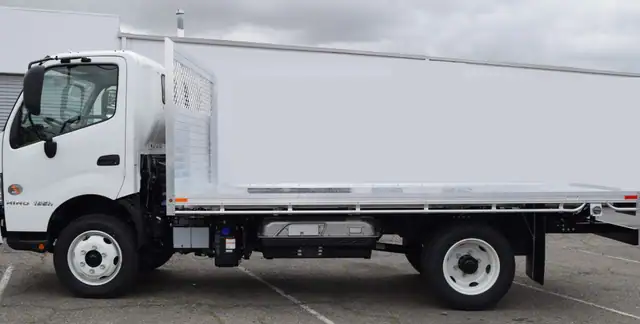 2019 Hino 195h with an 8' X 14' Alumbody aluminum flat bed with a heavy duty headboard constructed with stainless steel hardware and a dock bumper driver