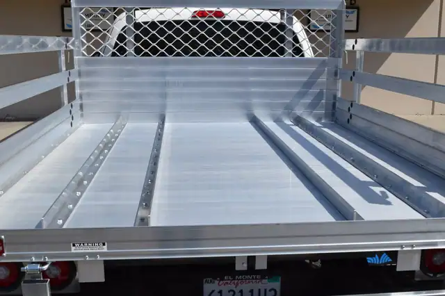 2020 Toyota Tacoma with a 6×76 aluminum body, 22" fold-down gates using the factory bumper with added wheel track in the bed
