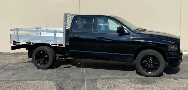 2005 Ram 1500, 6'6''x7' aluminum flatbed with 14'' lift out gates and dock bumper
