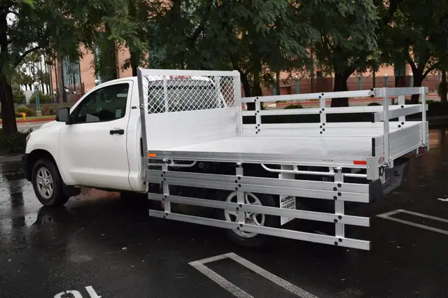 2017 Toyota Tacoma with a 6'X6'6" Alumbody stake bed, 33" lift-out gate using the factory bumper and customer-supplied cabinets