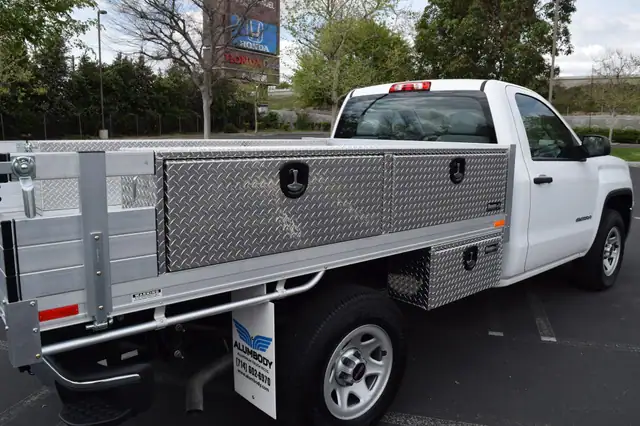 GMC Sierra 1500 with a 6’6” X 9’ Alumbody aluminum flat bed, 2 topsider tool boxes 16” X 13” X 88”, 2 underbody tool boxes 14” X 12” X 30”, and 16” fold down gates