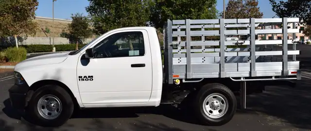 2016 Ram 1500 with a 6'6" X 7'6" Alumbody aluminum stake bed with 38" lift out stakes and dock bumper
