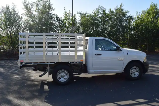 2015 Ram 1500 with a 6'6" X 7'6" Alumbody aluminum stake bed with 38" lift out stakes and dock bumper